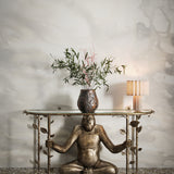 Playful monkey console table against warm sand watercolor mural. 