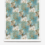 Wallpaper roll in a painterly tree print in gray and tan on a turquoise field.