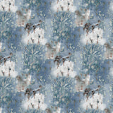 Detail of wallpaper in a painterly tree print in blue, gray and tan on a white field.