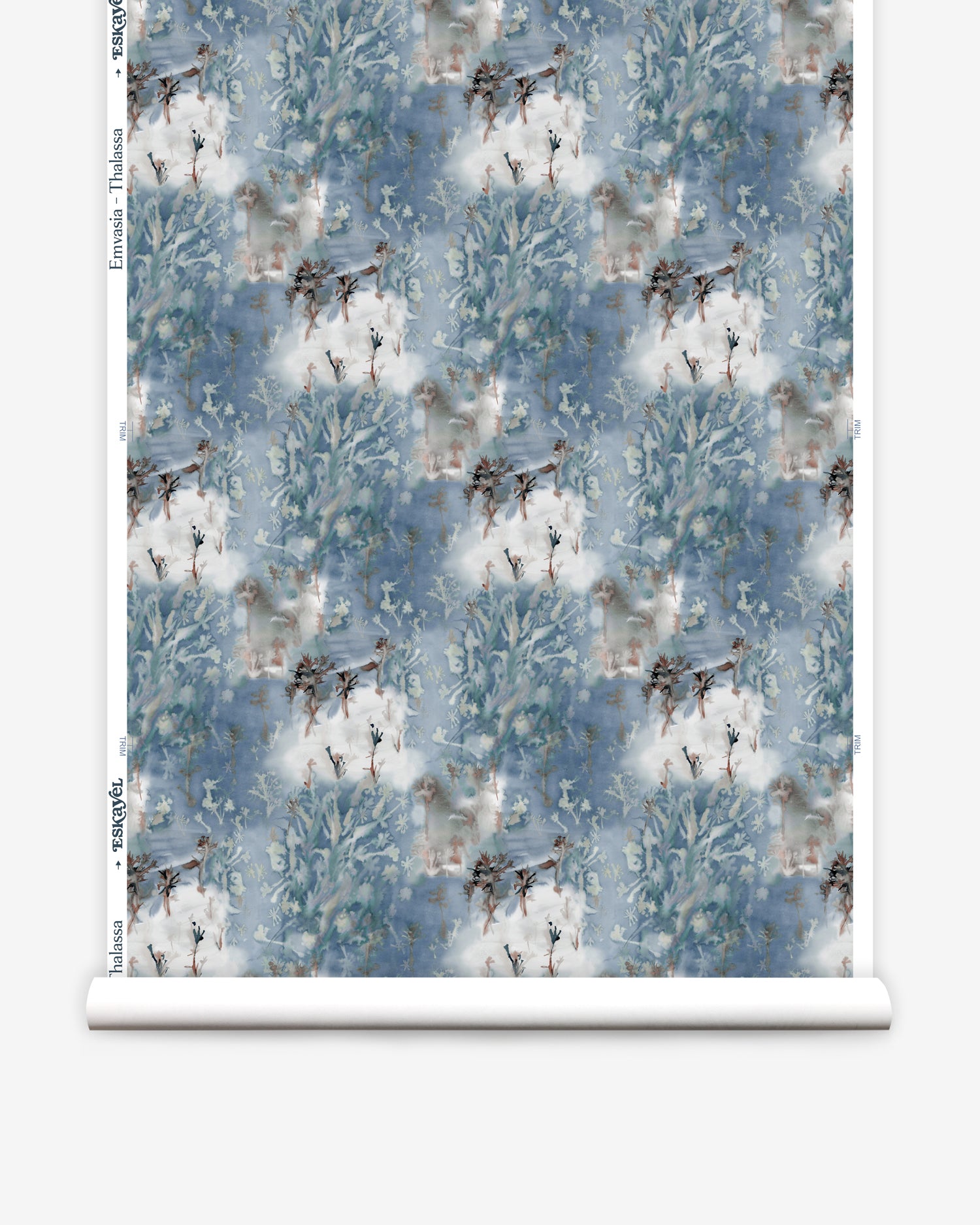 Wallpaper roll in a painterly tree print in blue, gray and tan on a white field.