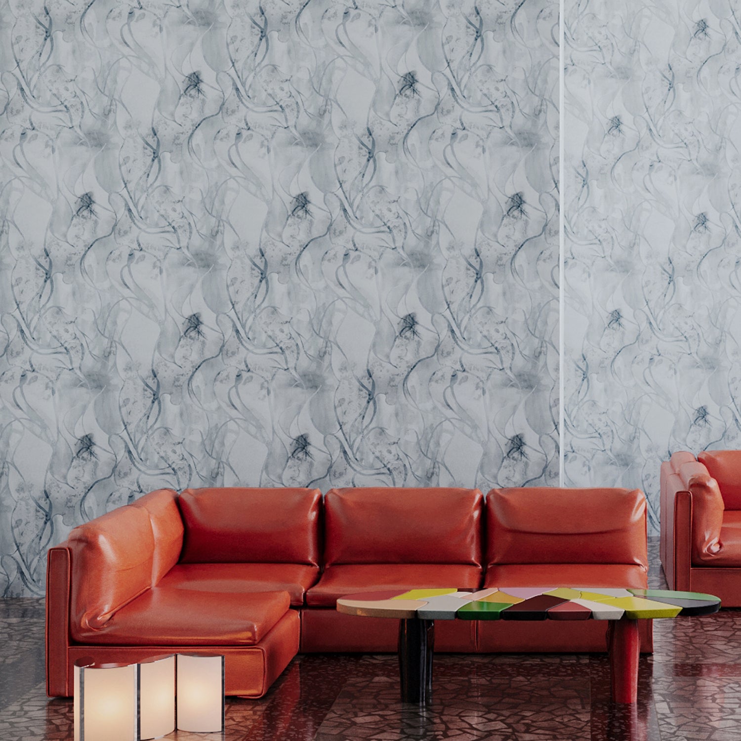 Retro orange leather couch against wallpaper in abstract floral bushstroke design in soft slate blue. 