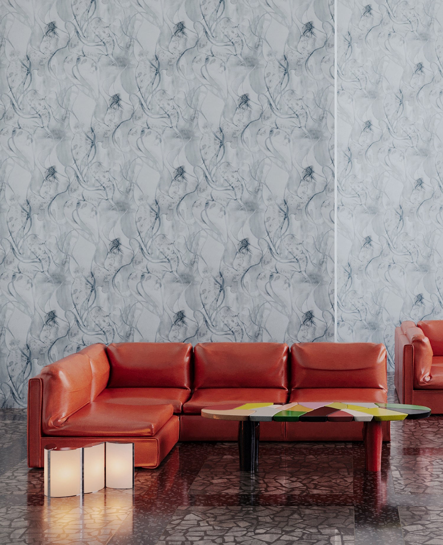 Retro orange leather couch against wallpaper in abstract floral bushstroke design in soft slate blue. 