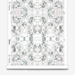 Wallpaper roll in a watercolor paint blotch print in gray and turquoise on a white field.