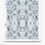 Wallpaper roll in a watercolor paint blotch print in blue, gray and purple on a white field.