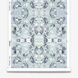 Wallpaper roll in a watercolor paint blotch print in blue, gray and purple on a white field.