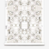 Wallpaper roll in a watercolor paint blotch print in purple and gray on a white field.