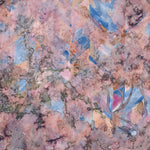 Detail of wallpaper in a painterly tree print in pink, orange, gray and blue.