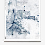 Wallpaper roll mural in a minimal splatter print in shadess of black and blue on a cream field.