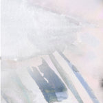 Wallpaper detail in an ombré watercolor print in shades of pink, gray and purple on a cream field.