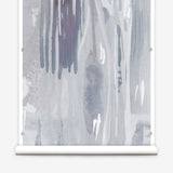 Wallpaper mural roll in a watercolor paint print in shades of purple and gray on a cream field.