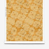 Wallpaper roll with yellow watercolor lace floral pattern on a white background.