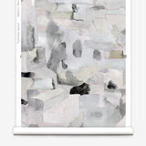 Wallpaper roll in a textural paint blotch print in shades of gray and blue on a light gray field.