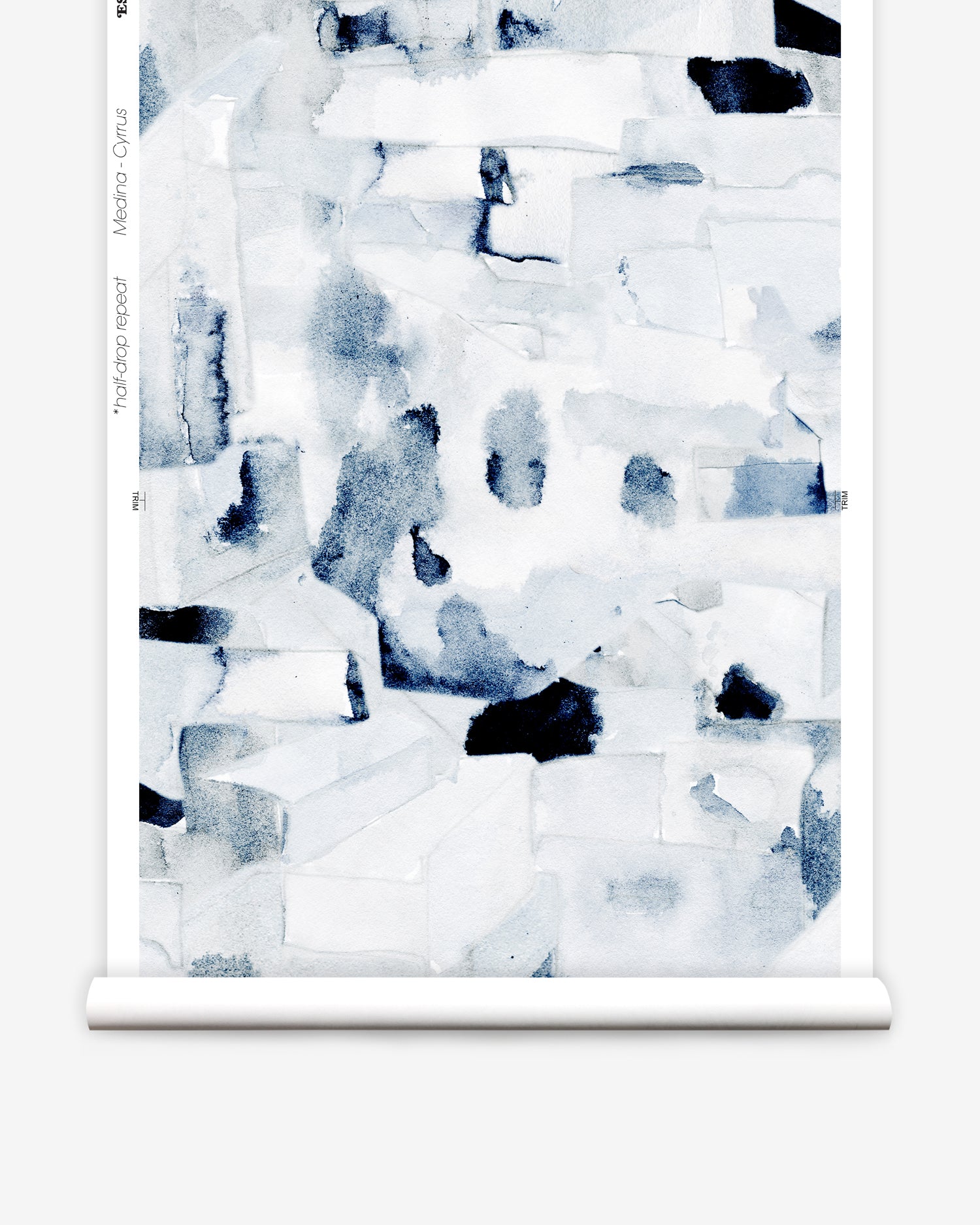 Wallpaper in a textural paint blotch print in shades of black and navy on a white field framed by a black bench with red flowers and black radiators. 