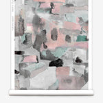 Wallpaper roll in a textural paint blotch print in shades of pink and gray on a white field.