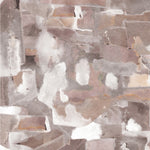 Wallpaper detail in a textural paint blotch print in shades of brown and tan on a white field.