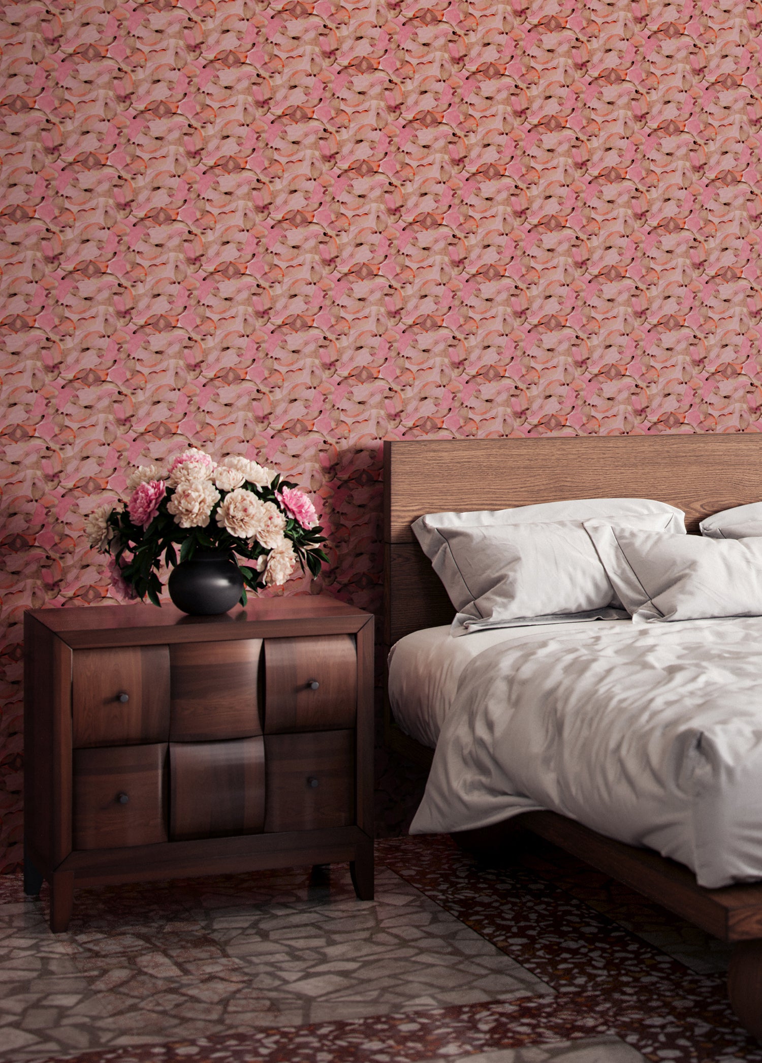 Bedroom scene with wooden furniture against a wallper in an undulating abstract watercolor motif in pink, orange and grey. 