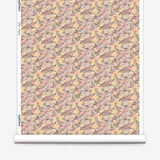 Wallpaper roll in an undulating abstract watercolor motif in pink, purple, tan and charcoal. 