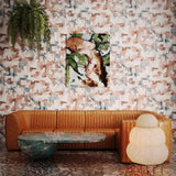 Brown fluted leather couch and vintage coffee table and paper lattern lamp against a geometric puzzle wallpaper in blush, grey and teal. 