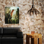 Living room scene with black leather couch, bird painting, wooden table and cieling lamp against a brown watercolor puzzle wallpaper. 
