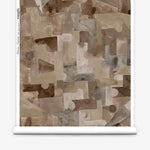 Wallpaper roll in a geometric puzzle piece watercolor pattern in brown and charcoal. 