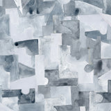 Wallpaper detail in a geometric puzzle piece watercolor pattern in shandes of slate blue. 