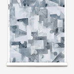 Wallpaper roll n a geometric puzzle piece watercolor pattern in shandes of slate blue. 