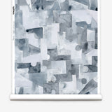 Wallpaper roll n a geometric puzzle piece watercolor pattern in shandes of slate blue. 
