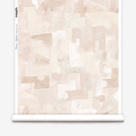 Wallpaper roll in a geometric puzzle piece watercolor pattern in pastel pink. 