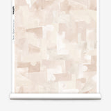 Wallpaper roll in a geometric puzzle piece watercolor pattern in pastel pink. 