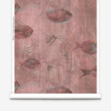 Wallpaper roll in an watercolor oceanic fish pattern in warm clay red. 