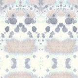 Wallpaper detail in a watercolor inkblot print in pastel pink and purple on a cream field.