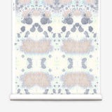 Wallpaper roll in a watercolor inkblot print in pastel pink and purple on a cream field.