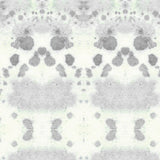 Wallpaper detail in a watercolor inkblot print in shades of blue-gray on a cream field.