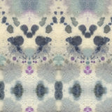 Wallpaper detail in a watercolor inkblot print in shades of blue and purple on a cream field.