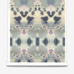 Wallpaper roll in a watercolor inkblot print in shades of blue and purple on a cream field.