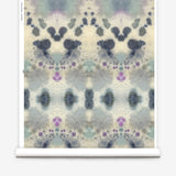 Wallpaper roll in a watercolor inkblot print in shades of blue and purple on a cream field.