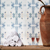 Wallpaper installed behind a plunge pool with props in a watercolor ink splash print in shades of pastel blue and pink on a cream field.