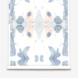 Wallpaper roll in a watercolor ink splash print in shades of pastel blue and pink on a cream field.