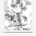 Wallpaper roll in an watercolor palm frond pattern in shades of grey.