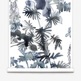 Wallpaper roll in an watercolor palm frond pattern in shades of dark blue. 