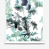 Wallpaper roll in an watercolor palm frond pattern in shades of teal and green. 