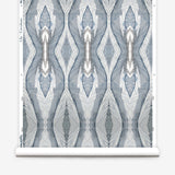 Wallpaper roll in a watercolor diamond print in shades of gray and navy on a cream field.