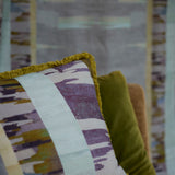 Decorative pillow with fringe in a watercolors stripe design.