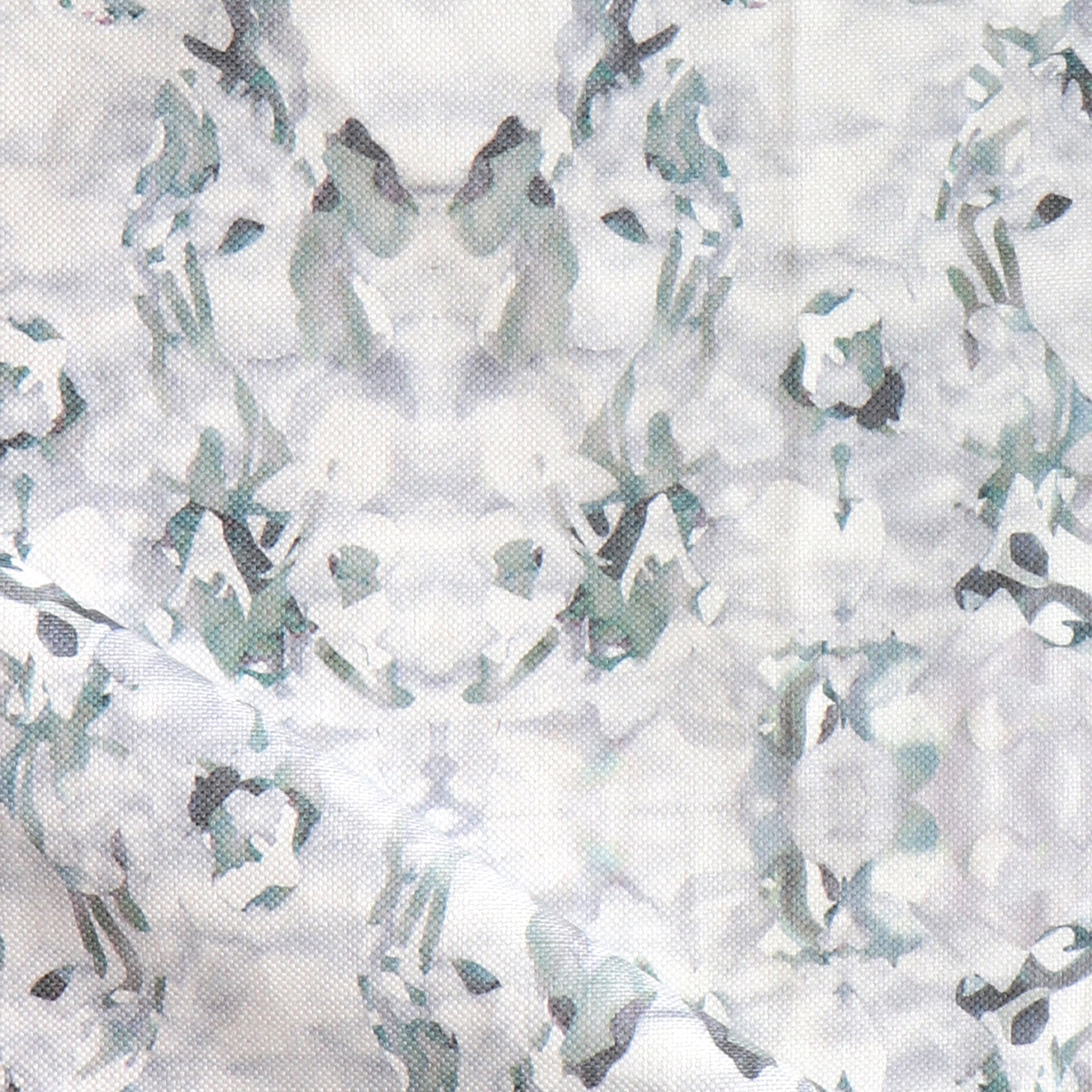 Detail of fabric in a watercolor paint blotch print in gray and turquoise on a white field.