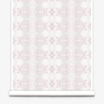 Partially unrolled wallpaper yardage in a striped ink blot print in shades of tan and pink on a cream field.