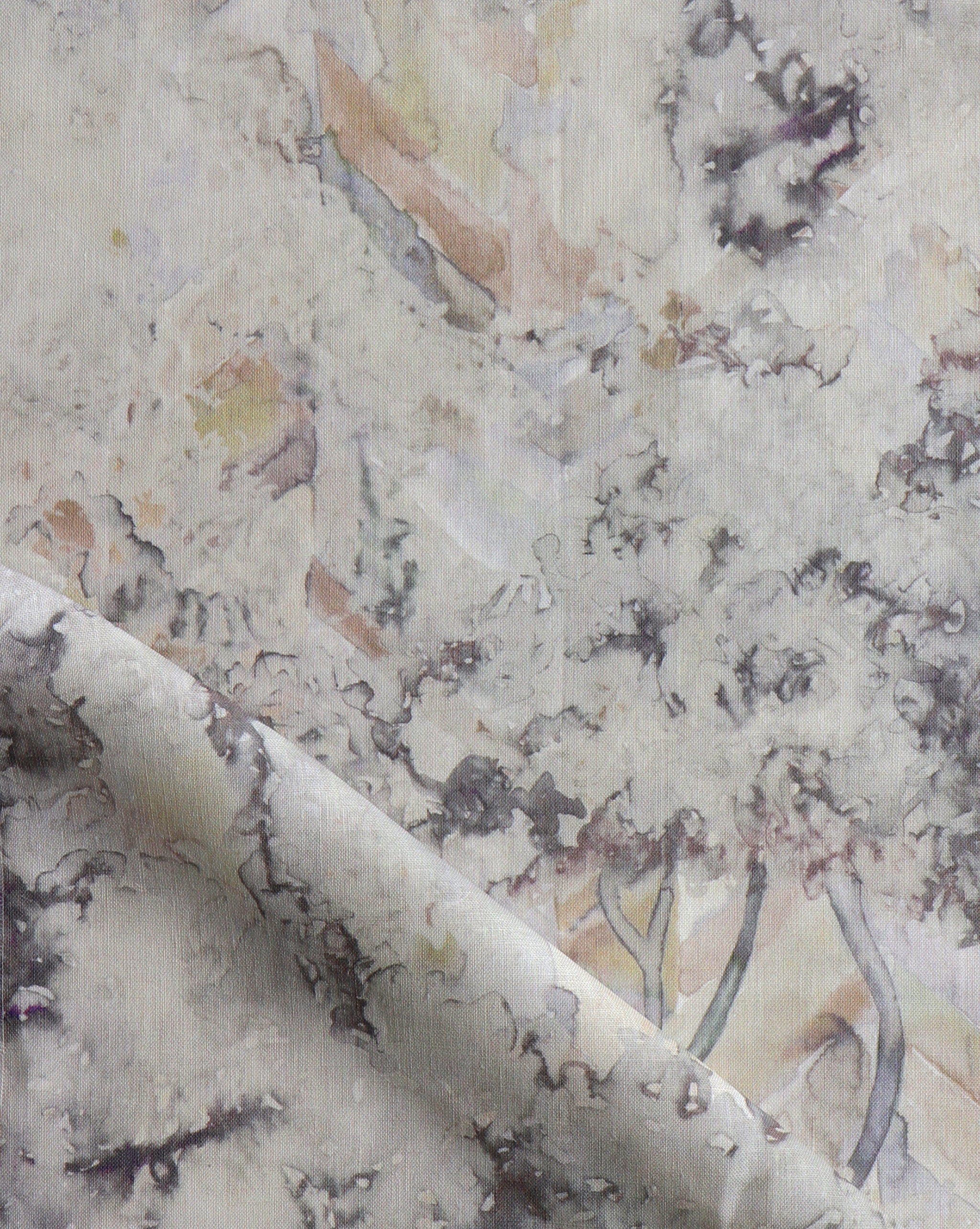 Detail of fabric in a painterly tree print in gray, brown and purple.