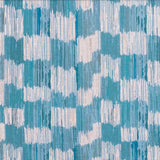 Detail of fabric in an abstract check print in shades of blue, turquoise and white.
