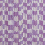 Detail of fabric in an abstract check print in shades of purple and cream.