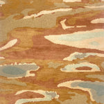 Handknotted rug in an abstract watercolor design in shades of orange, tan, cream and grey. 