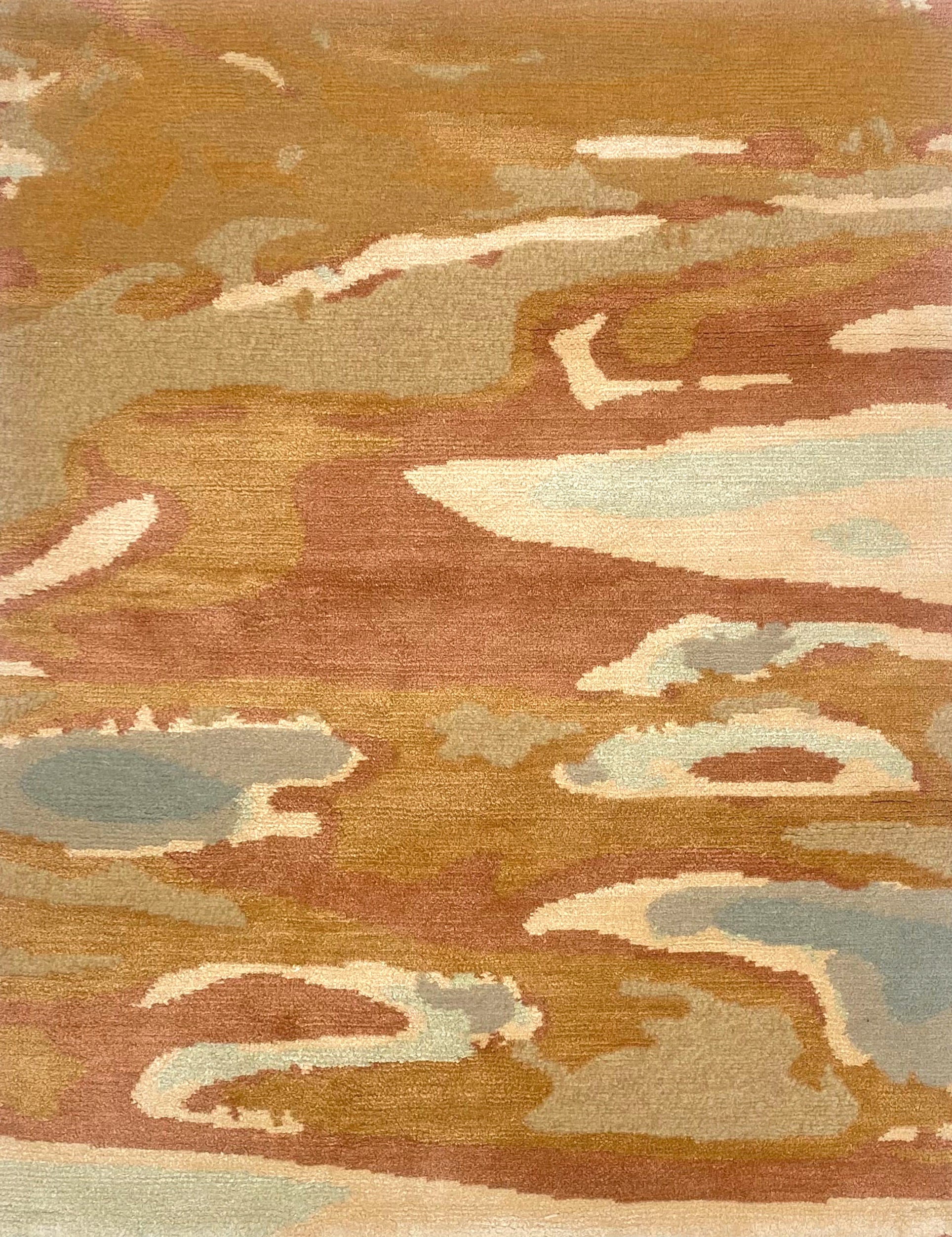 Handknotted rug in an abstract watercolor design in shades of orange, tan, cream and grey. 